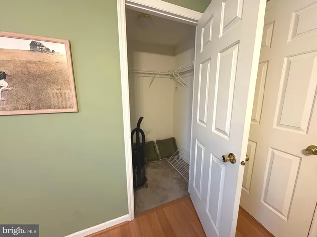 a spacious bedroom with a bed and a chandelier