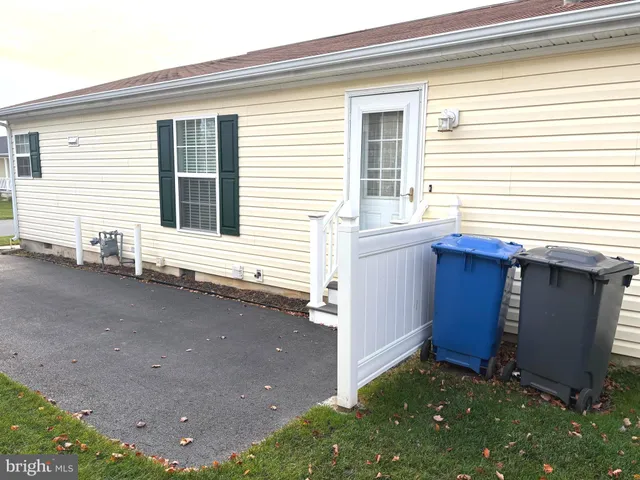 a view of a house with a small yard and wooden floor and fence