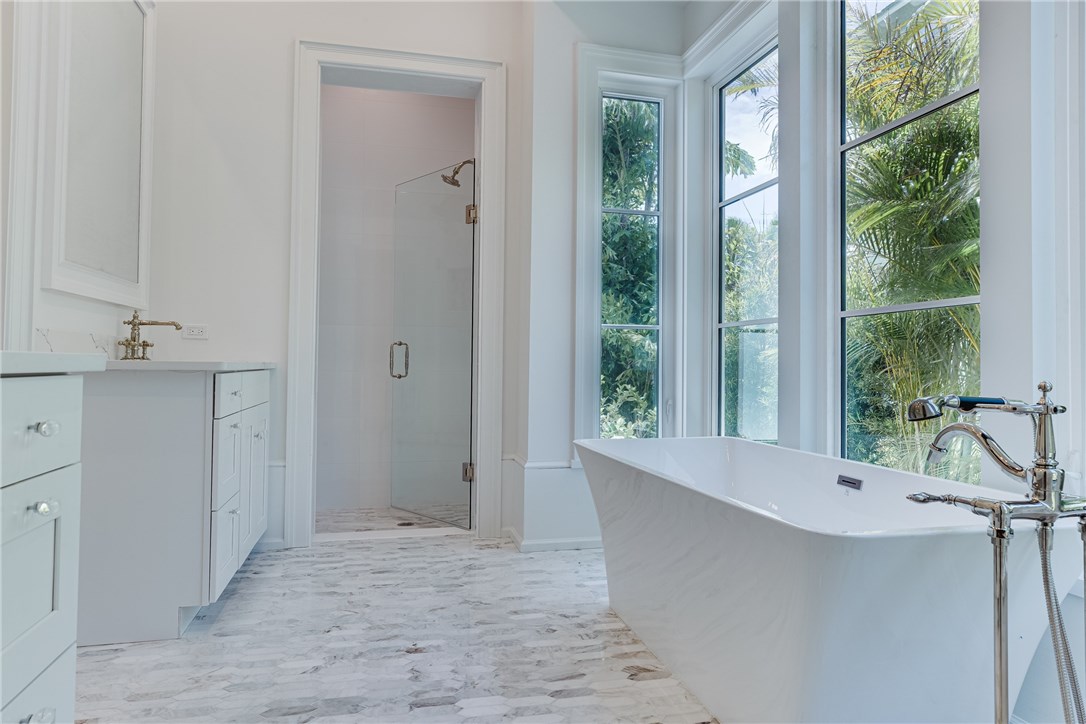 1375 Sandy Lane Vero Beach, FL 32963 - Photo 12 of 36 a bathroom with a tub sink and mirror