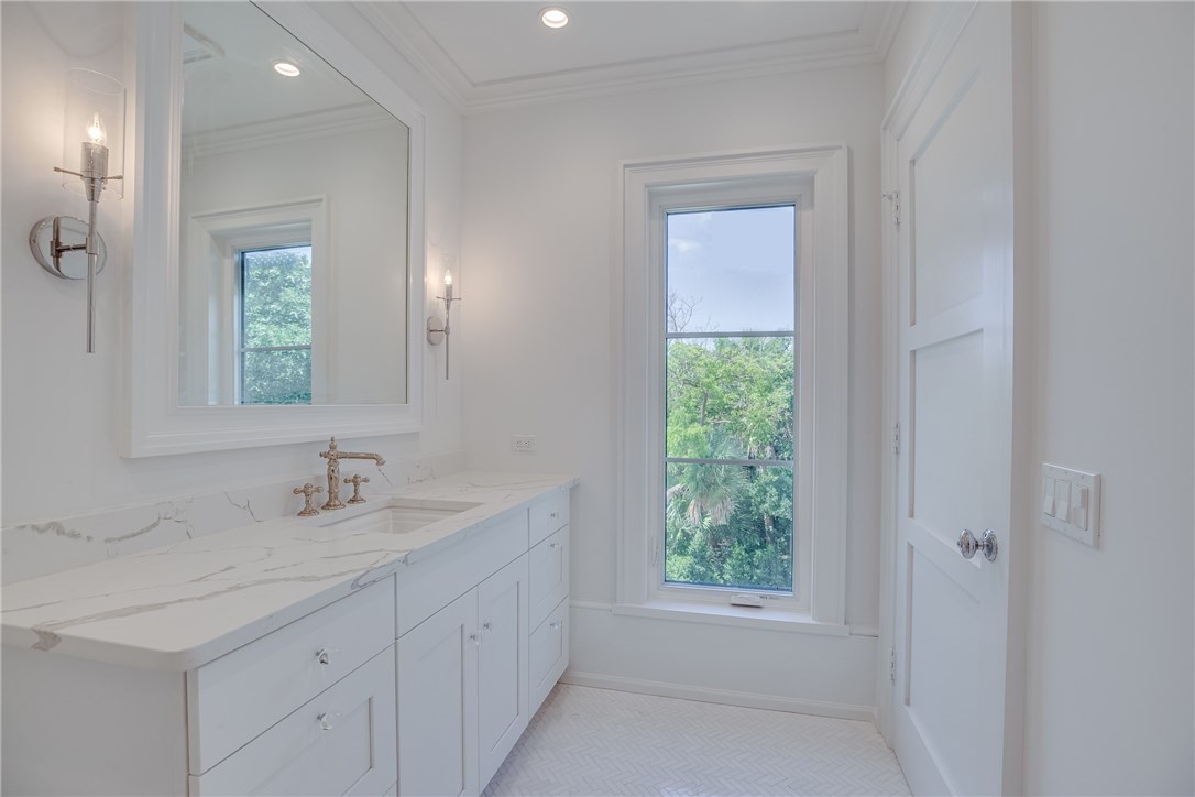 1375 Sandy Lane Vero Beach, FL 32963 - Photo 26 of 36 a bathroom with a sink a vanity a window and a mirror