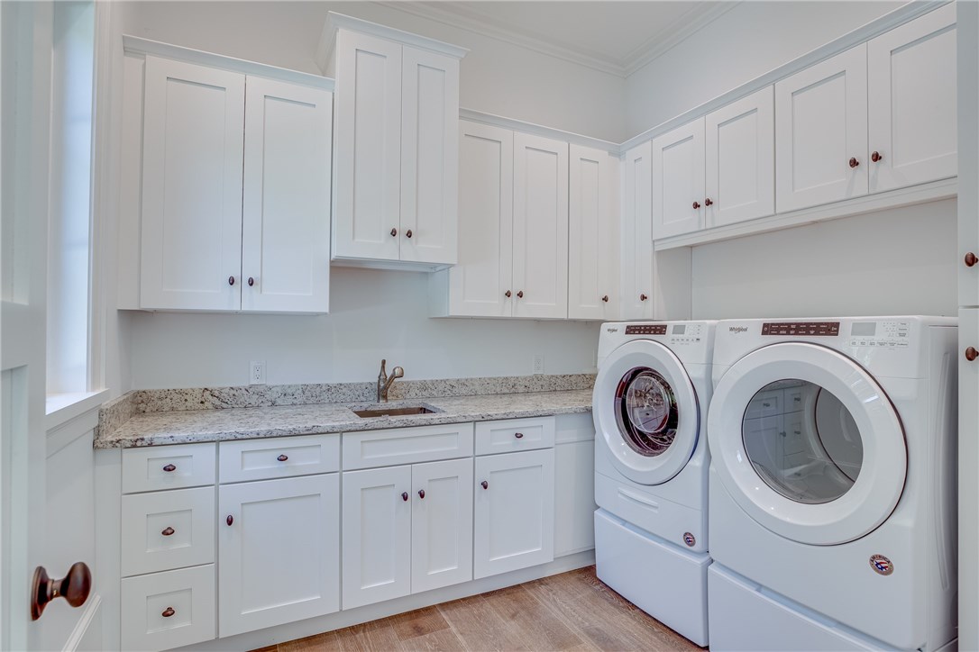 1375 Sandy Lane Vero Beach, FL 32963 - Photo 29 of 36 a view of cabinets a washer and dryer