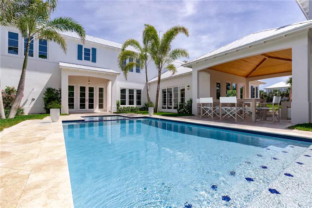 1375 Sandy Lane Vero Beach, FL 32963 - Photo 31 of 36 a view of a swimming pool with outdoor seating