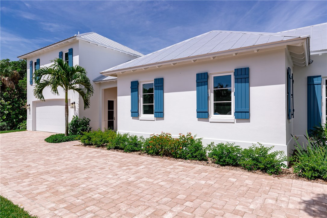 1375 Sandy Lane Vero Beach, FL 32963 - Photo 33 of 36 a front view of a house with a yard and garage