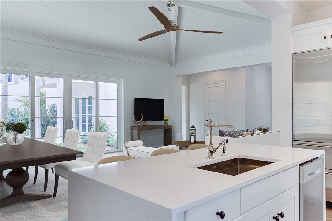 1375 Sandy Lane Vero Beach, FL 32963 - Photo 8 of 36 a large white kitchen with a sink and a large window