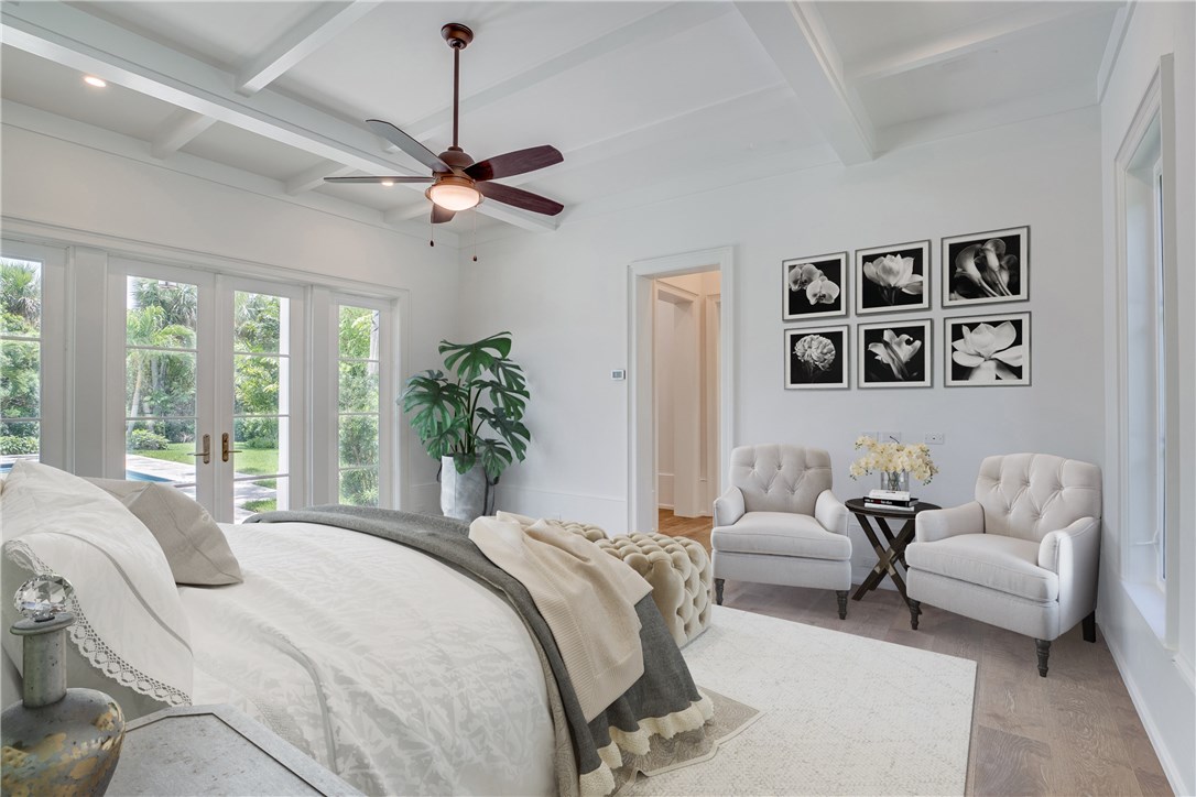 1375 Sandy Lane Vero Beach, FL 32963 - Photo 10 of 36 a bedroom with a large bed couch and a window