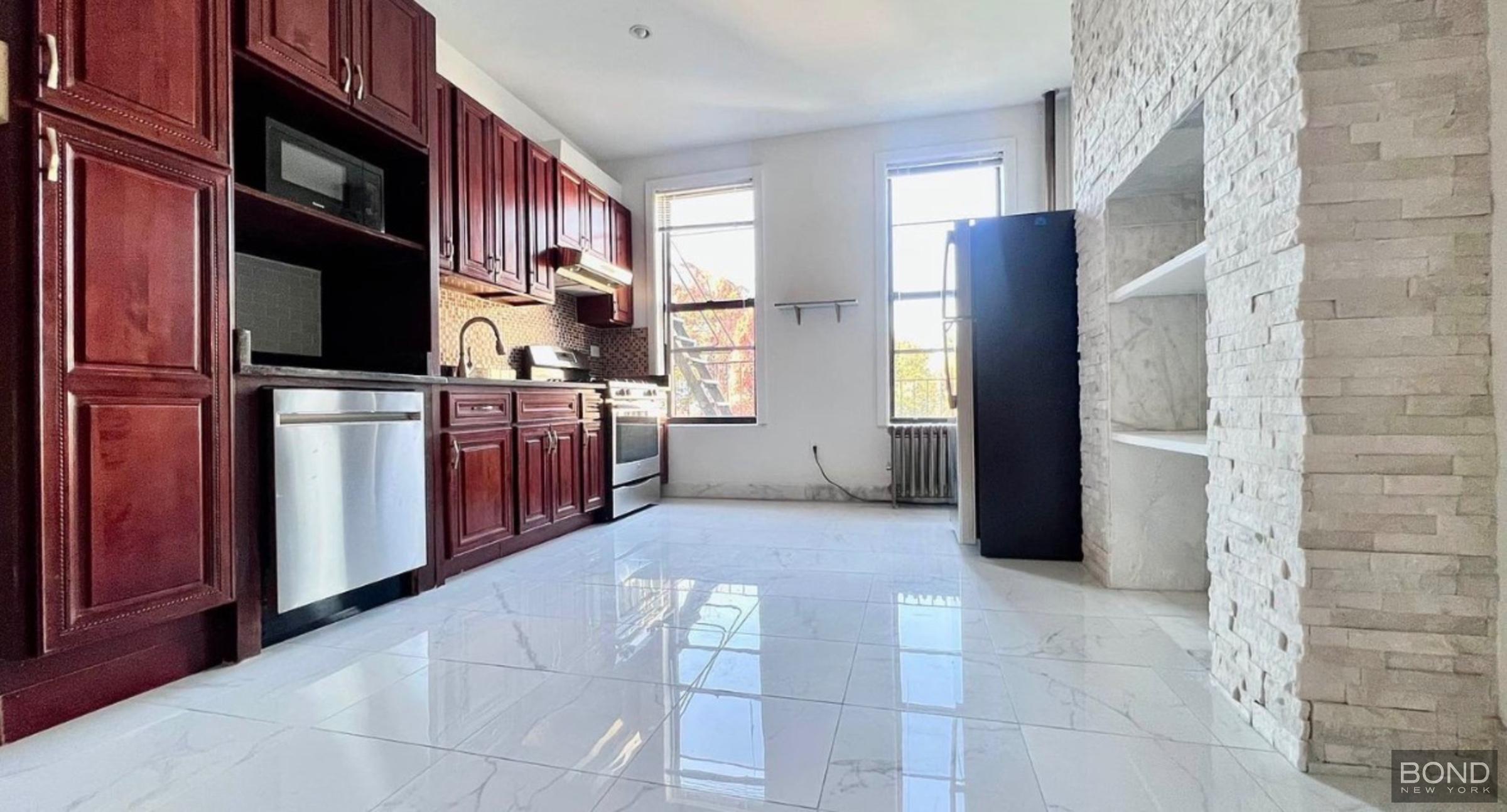842 Bushwick Avenue, Unit 2R Brooklyn, NY 11221 - Photo 1 of 8 a kitchen with stainless steel appliances granite countertop a refrigerator and a stove