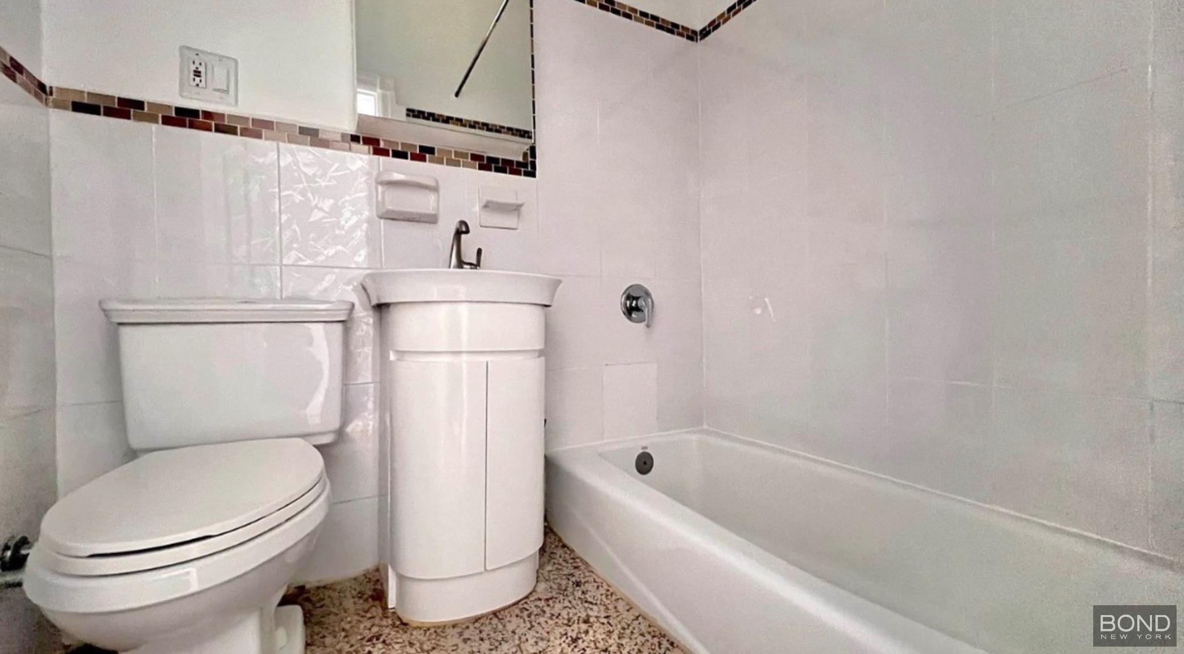 842 Bushwick Avenue, Unit 2R Brooklyn, NY 11221 - Photo 8 of 8 a bathroom with a toilet and a bathtub