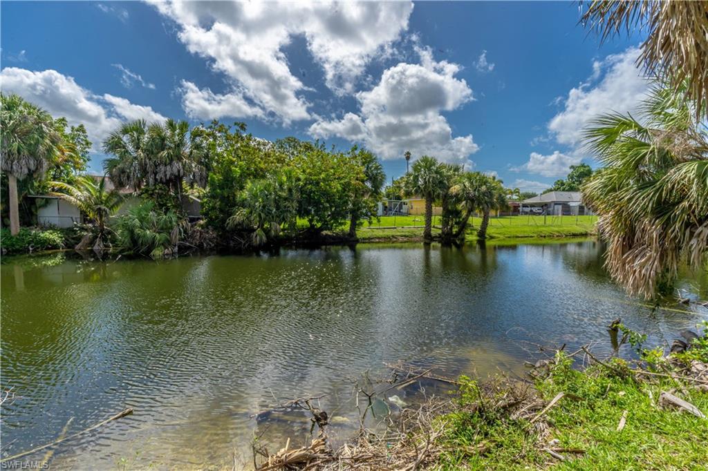 2100 55th Street Southwest Naples, FL 34116 - Photo 28 of 50 a view of a lake with a yard