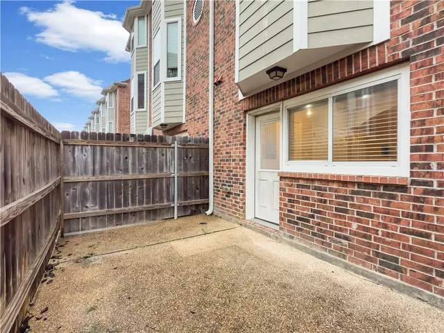 a view of a brick house with a large window