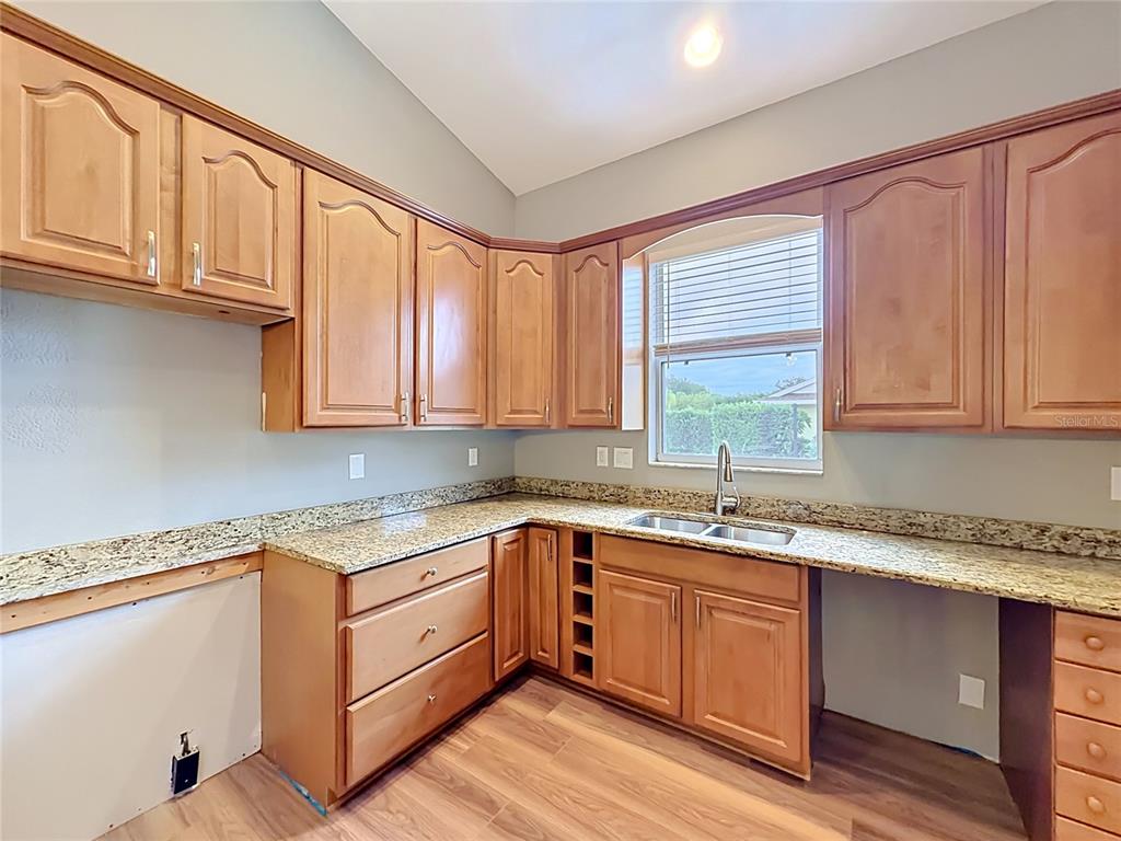 28549 Shirley Shores Road Tavares, FL 32778 - Photo 21 of 65 a kitchen with a sink cabinets appliances and a window