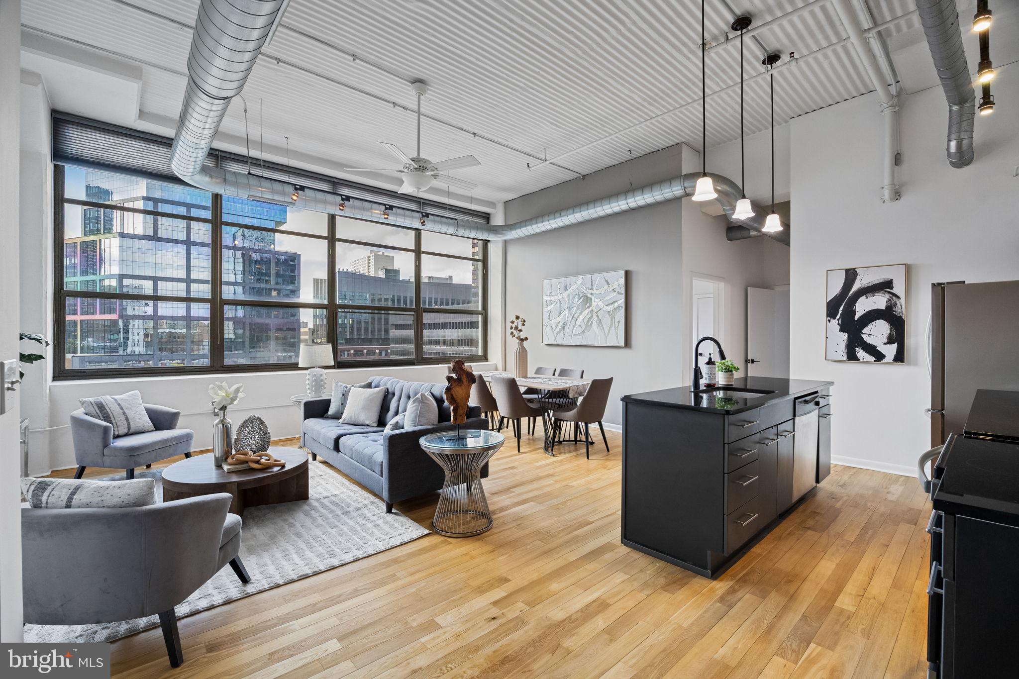 2200-28 Arch Street, Unit 612 Philadelphia, PA 19103 - Photo 1 of 43 a living room with furniture and a large window