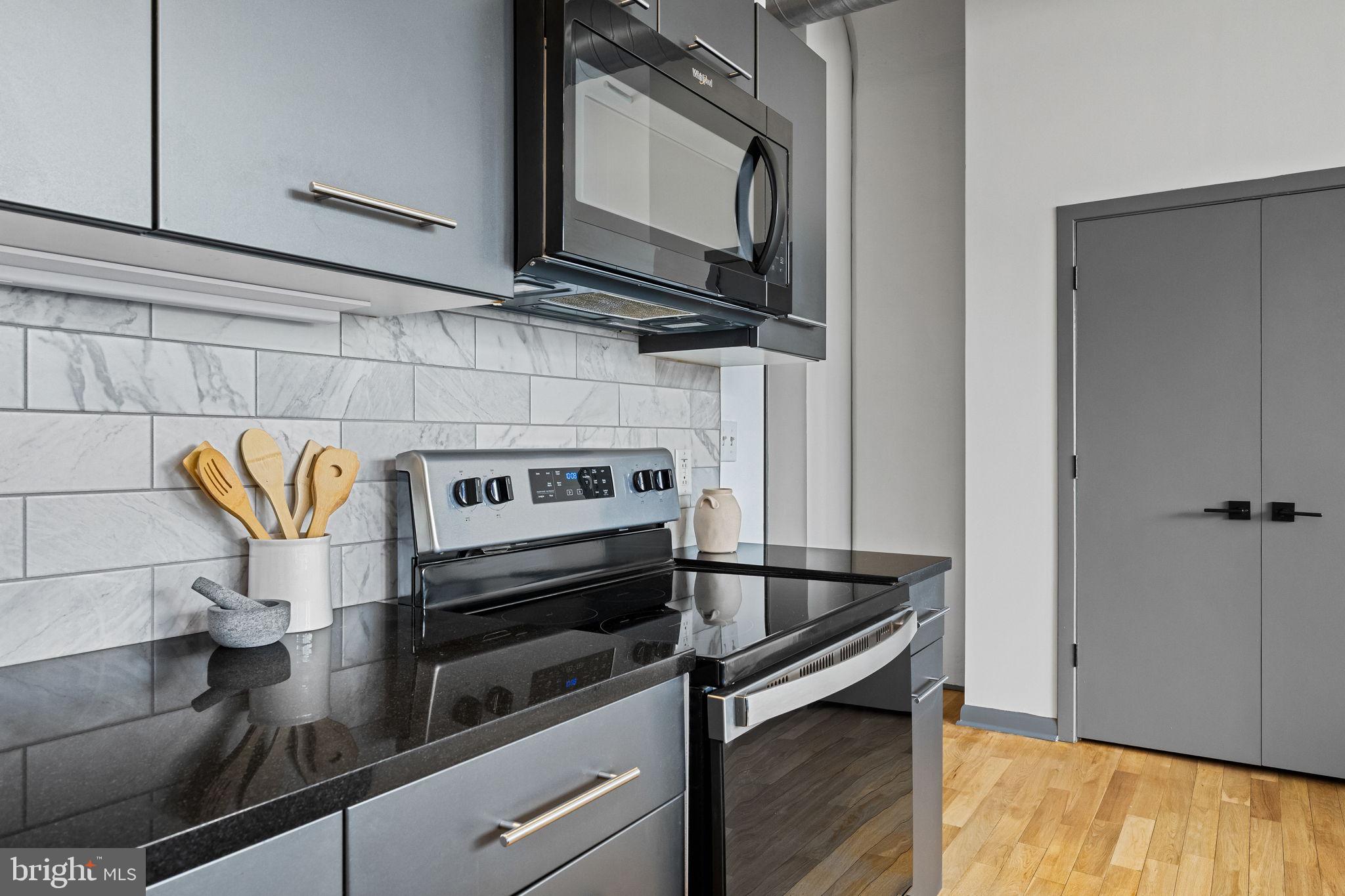 2200-28 Arch Street, Unit 612 Philadelphia, PA 19103 - Photo 11 of 43 a kitchen with a stove and a microwave