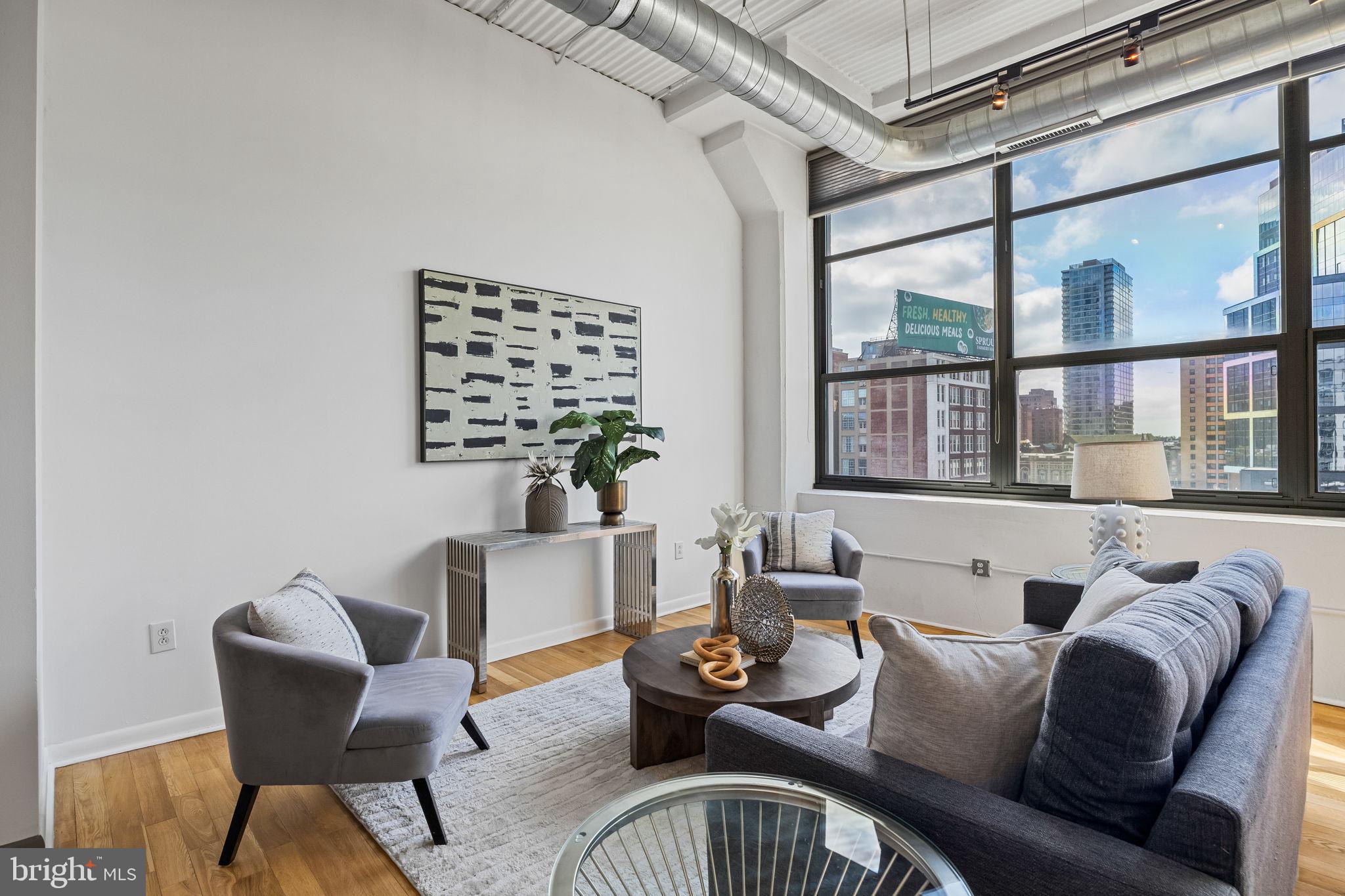 2200-28 Arch Street, Unit 612 Philadelphia, PA 19103 - Photo 14 of 43 a living room with furniture and a large window