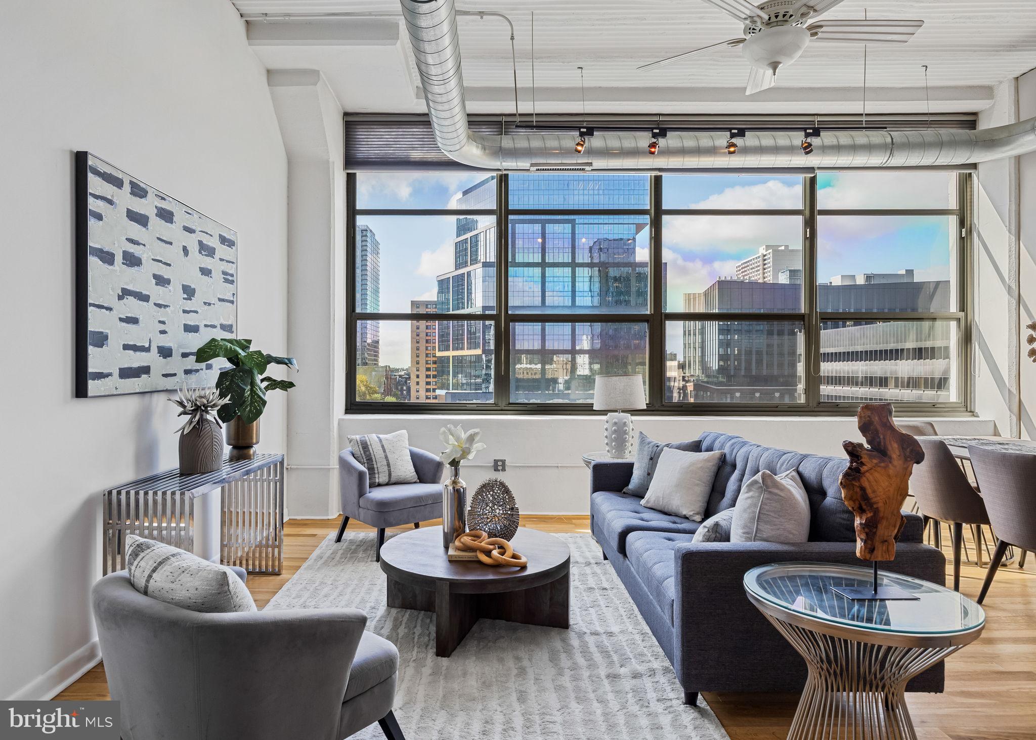 2200-28 Arch Street, Unit 612 Philadelphia, PA 19103 - Photo 15 of 43 a living room with furniture and a large window