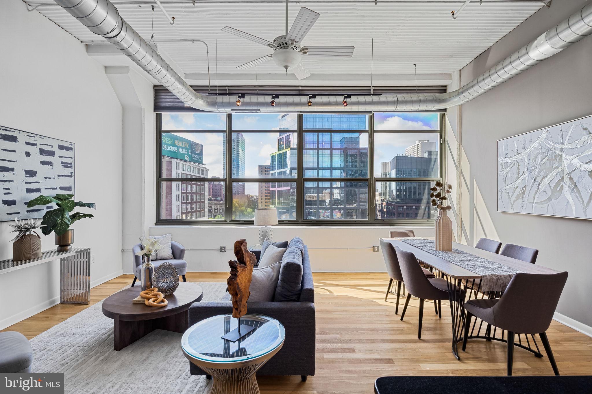 2200-28 Arch Street, Unit 612 Philadelphia, PA 19103 - Photo 16 of 43 a living room with furniture and a large window