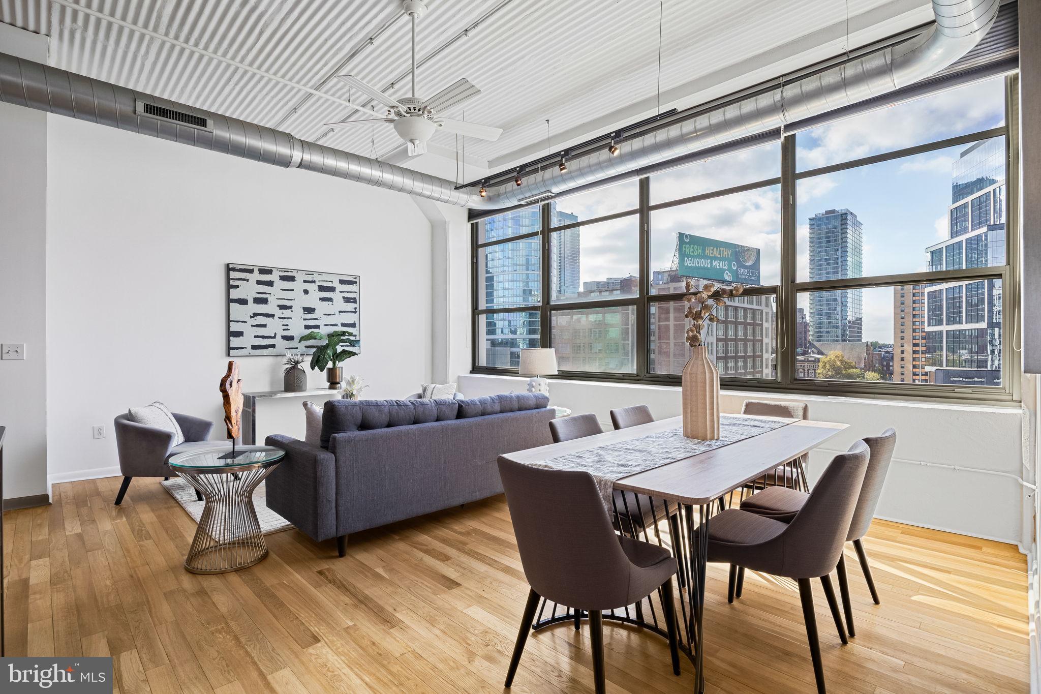 2200-28 Arch Street, Unit 612 Philadelphia, PA 19103 - Photo 17 of 43 a view of a dining room with furniture window and wooden floor