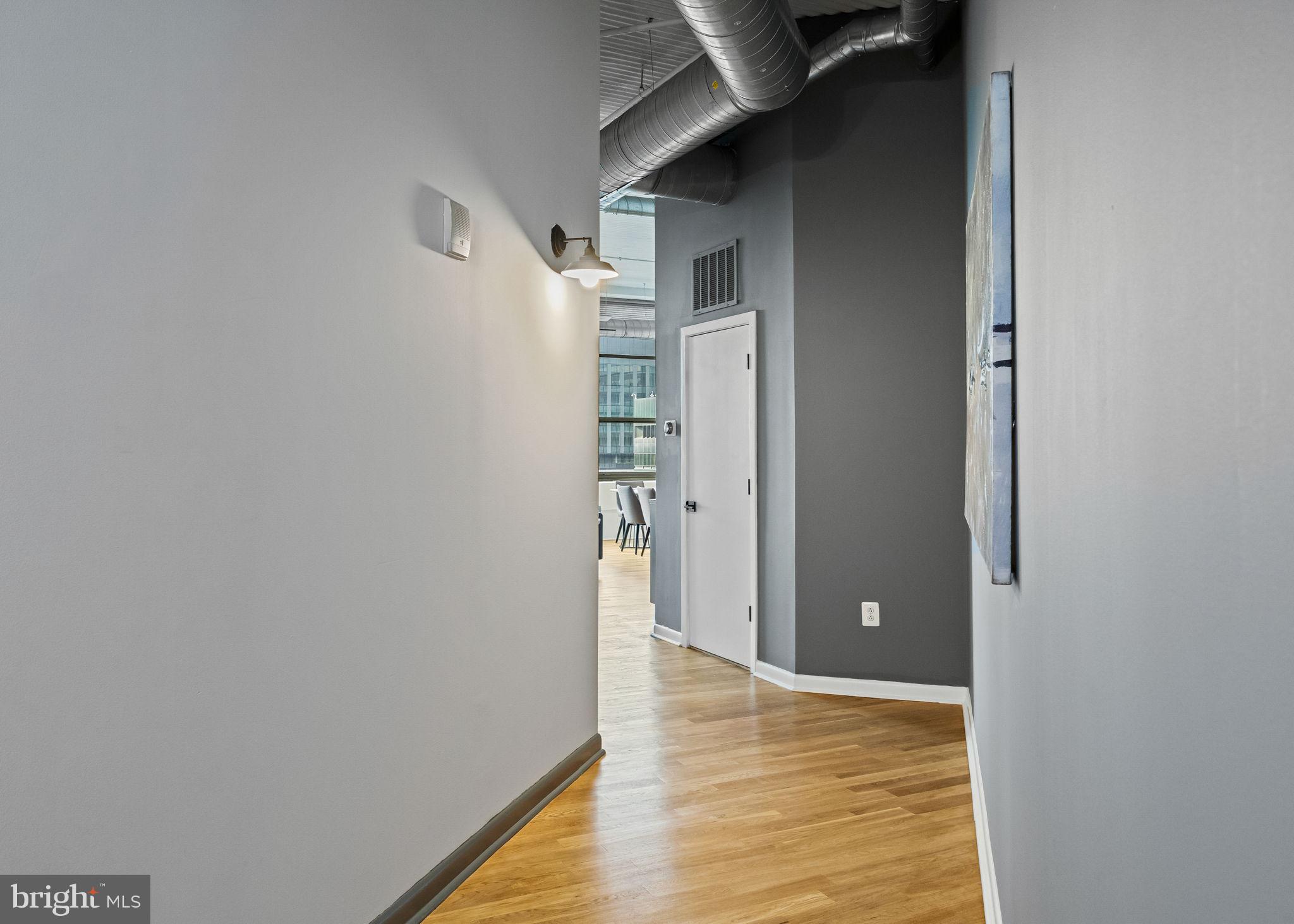 2200-28 Arch Street, Unit 612 Philadelphia, PA 19103 - Photo 20 of 43 a view of an empty room with wooden floor and a bathroom