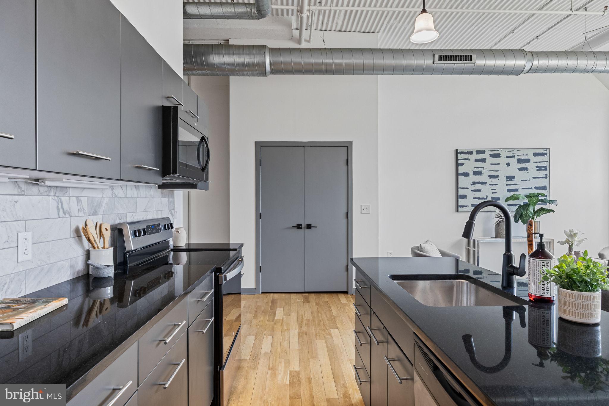 2200-28 Arch Street, Unit 612 Philadelphia, PA 19103 - Photo 23 of 43 a kitchen with a sink and a stove top oven