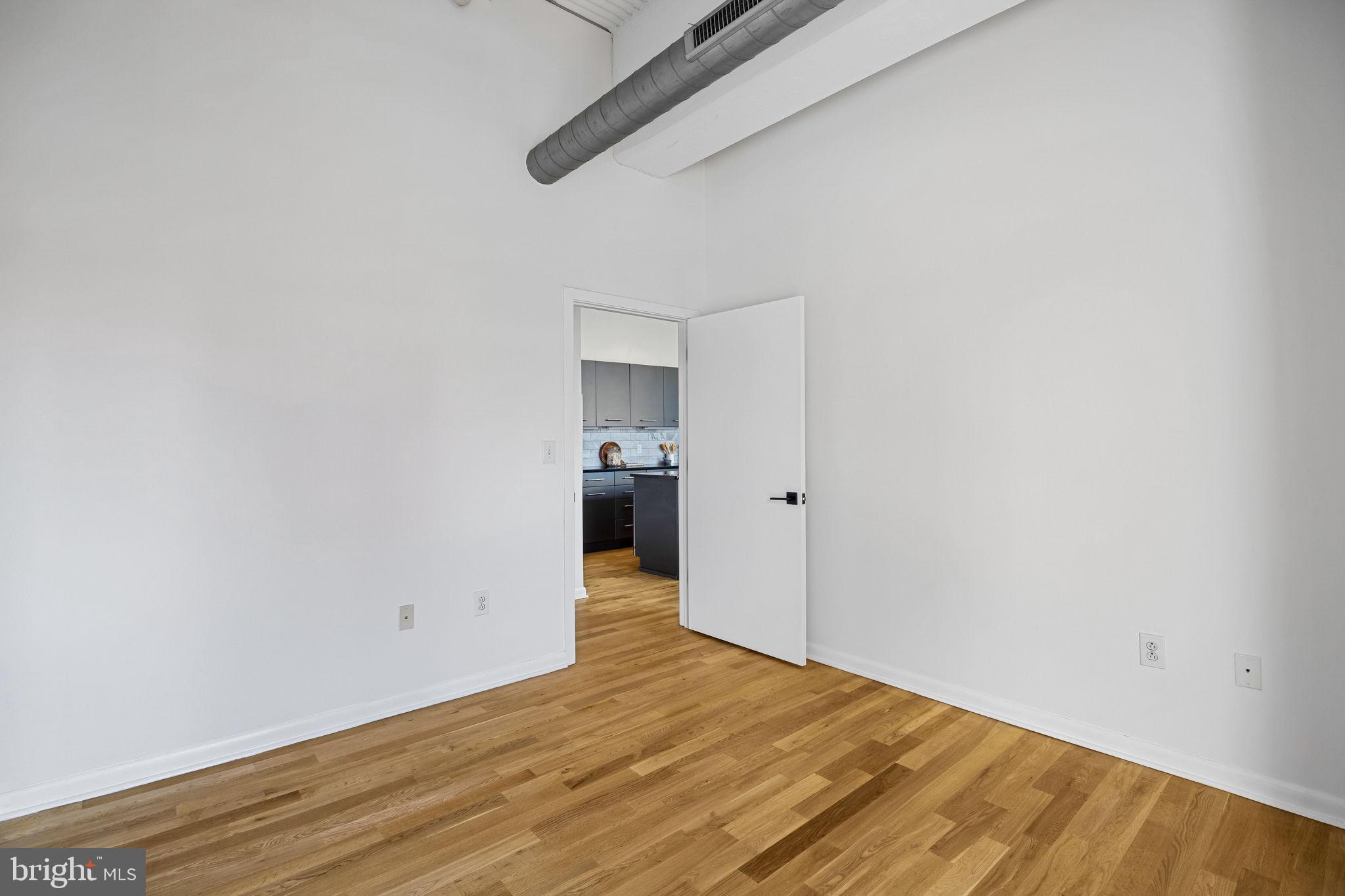 2200-28 Arch Street, Unit 612 Philadelphia, PA 19103 - Photo 27 of 43 a view of empty room with wooden floor