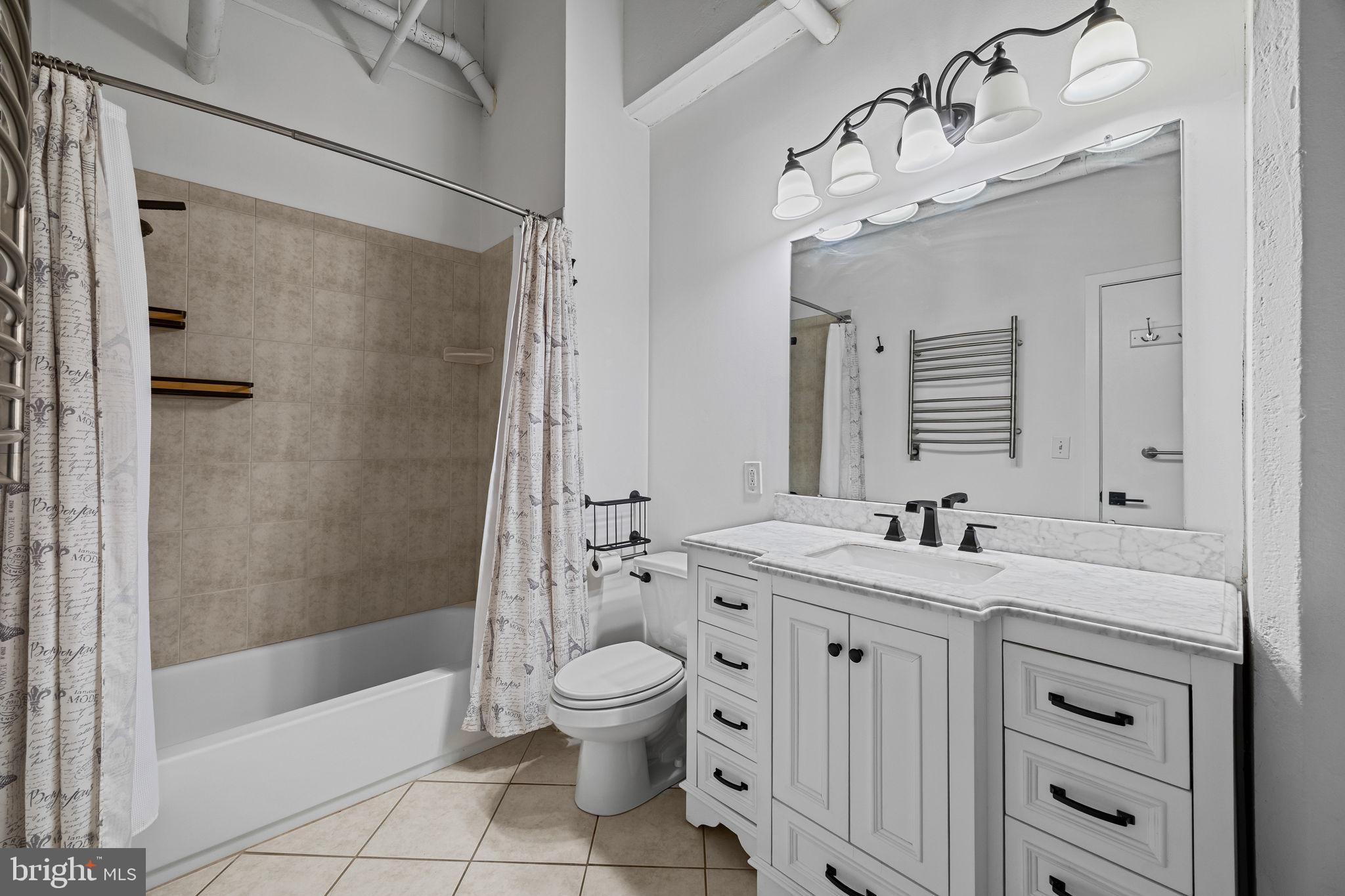 2200-28 Arch Street, Unit 612 Philadelphia, PA 19103 - Photo 30 of 43 a bathroom with a double vanity sink mirror toilet shower and bathtub