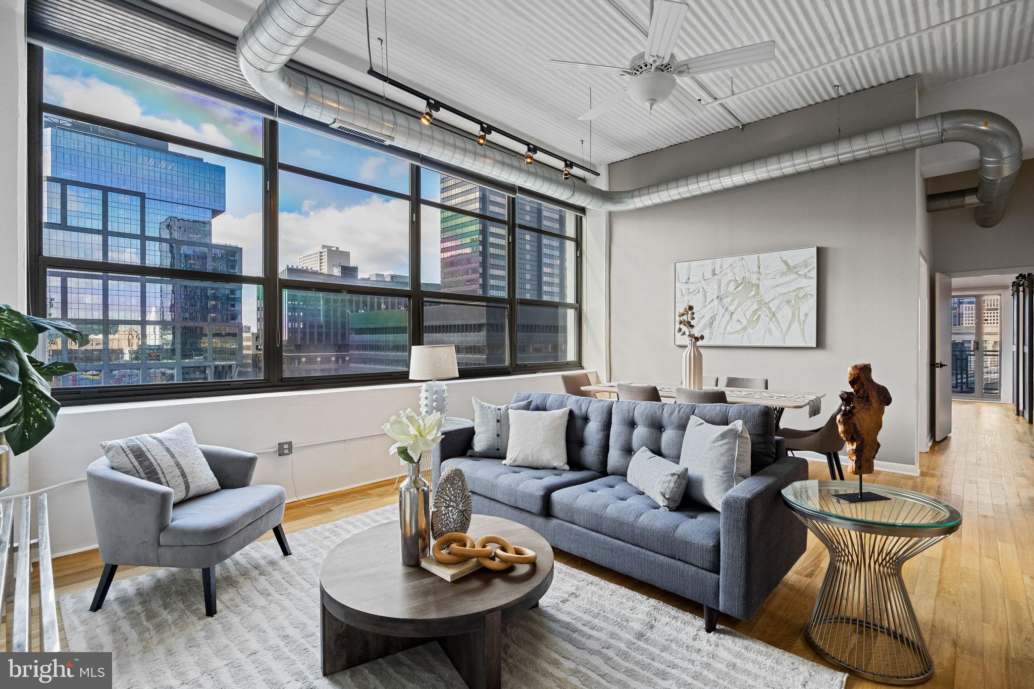 2200-28 Arch Street, Unit 612 Philadelphia, PA 19103 - Photo 10 of 43 a living room with furniture and a large window