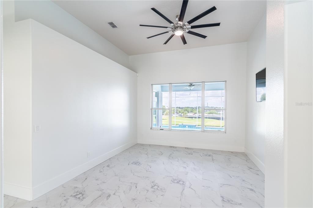 3862 Beacon Ridge Way Clermont, FL 34711 - Photo 13 of 56 an empty room with a window and a fan