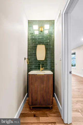 a living room with a couch and a wooden floor
