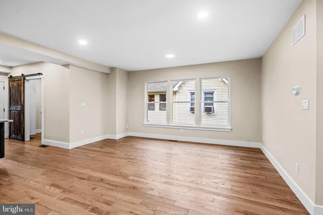 a room with stainless steel appliances kitchen island granite countertop a large counter top and a floors