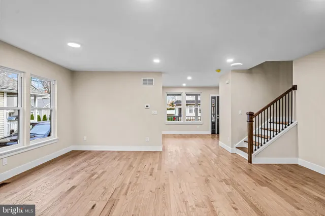 a kitchen with granite countertop stainless steel appliances a sink stove refrigerator and cabinets