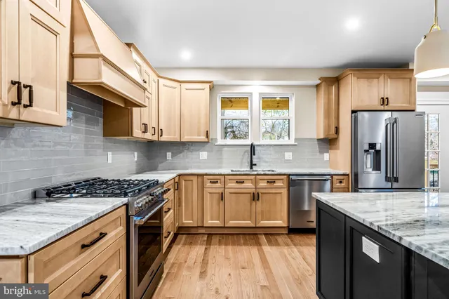 a kitchen with stainless steel appliances granite countertop a stove sink and cabinets