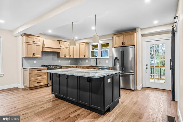 a kitchen with stainless steel appliances granite countertop wooden floors and sink
