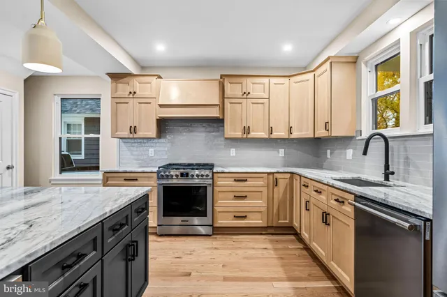 a kitchen with granite countertop a stove and a microwave oven