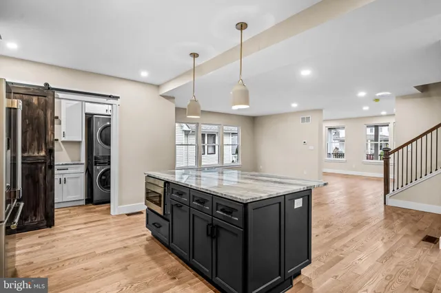 a view of a hallway with wooden floor and entryway