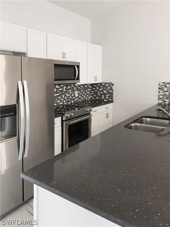 7418 Albany Road, Unit 7418 Fort Myers, FL 33967 - Photo 4 of 11 a kitchen with stainless steel appliances granite countertop a refrigerator and a stove