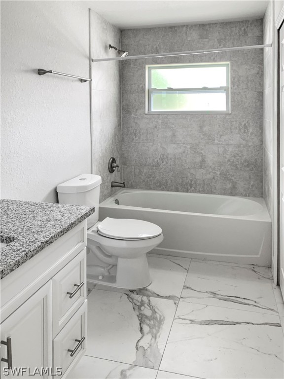 7418 Albany Road, Unit 7418 Fort Myers, FL 33967 - Photo 7 of 11 a bathroom with a granite countertop toilet a sink and a bathtub