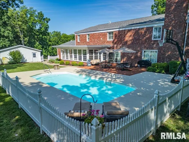a view of a house with backyard and sitting area