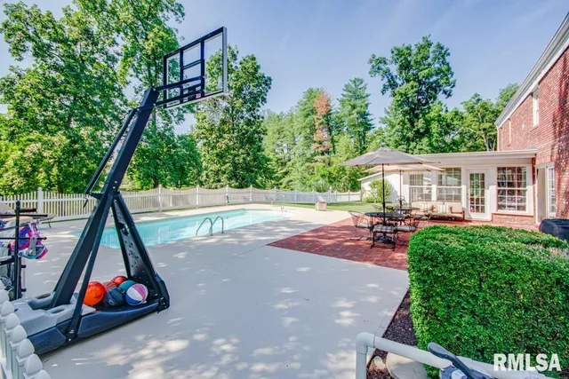 a view of an house with swimming pool and sitting area