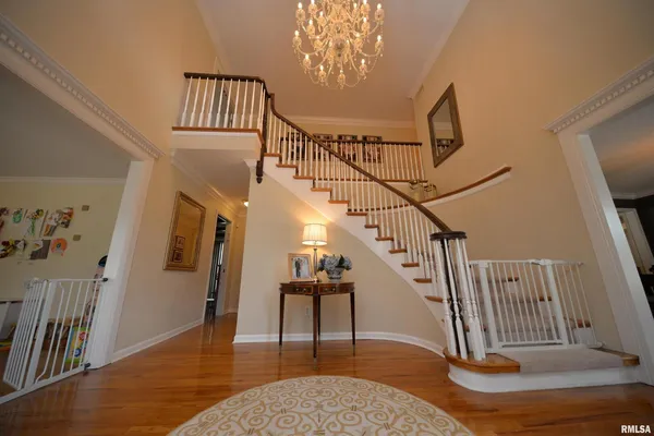 a dining room with furniture a chandelier and wooden floor