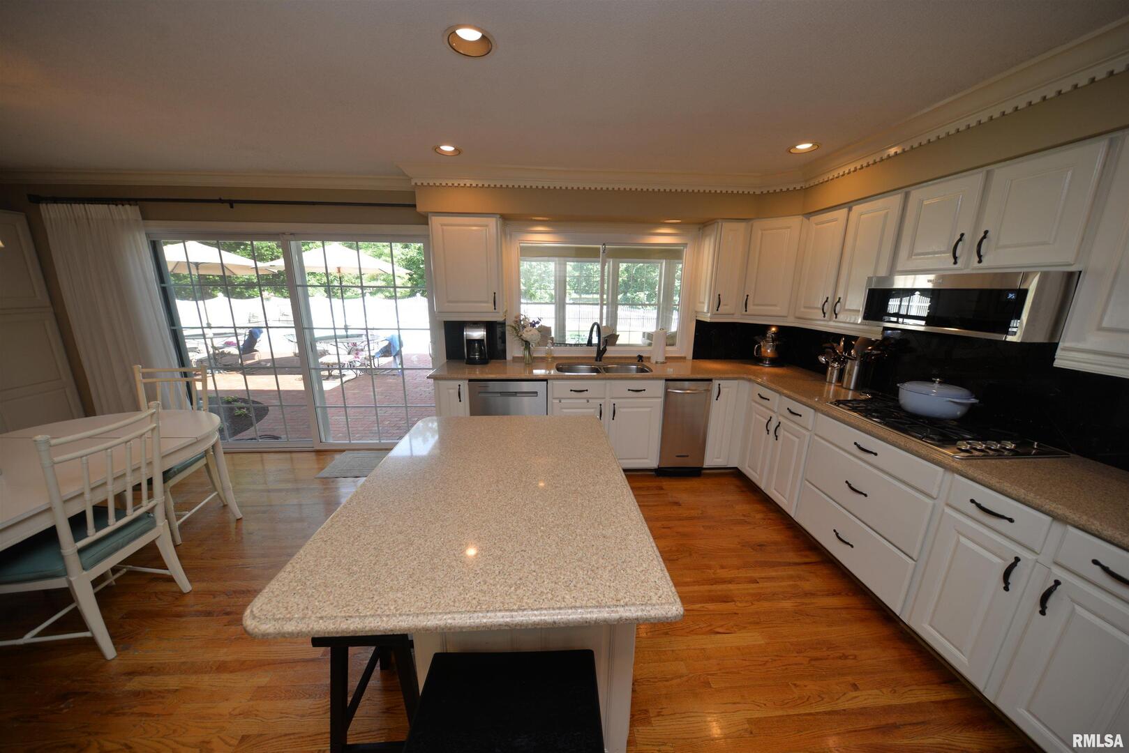 616 Seville Drive Mount Vernon, IL 62864 - Photo 30 of 62 a large kitchen with kitchen island a large counter space a sink a window and stainless steel appliances