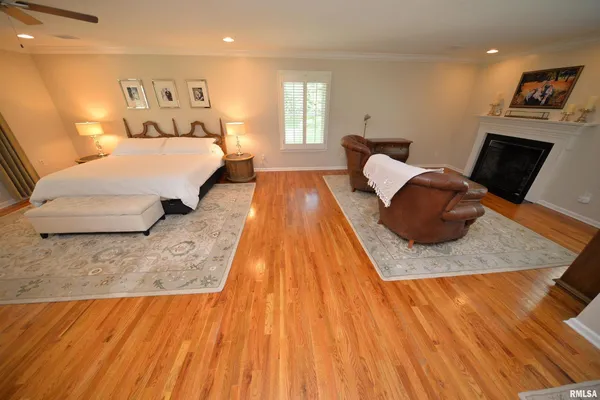 a bedroom with a bed window and a mirror