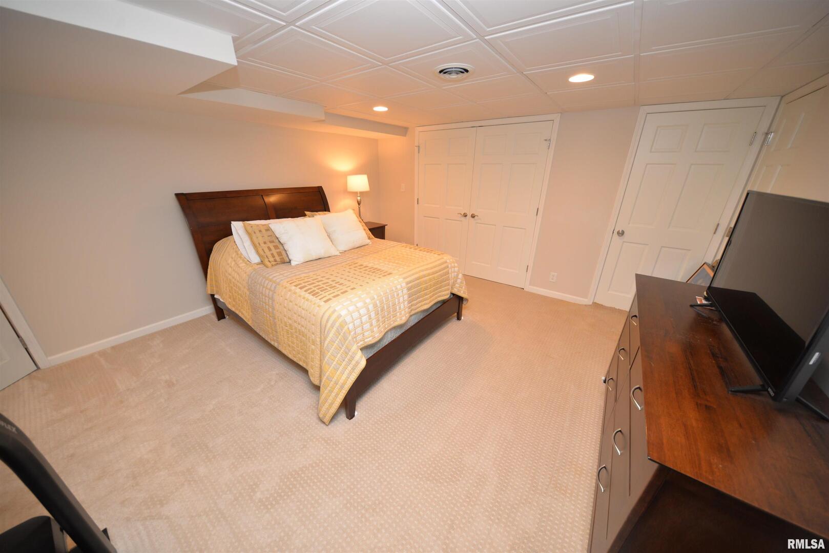 616 Seville Drive Mount Vernon, IL 62864 - Photo 62 of 62 a spacious bedroom with a bed and a flat screen tv