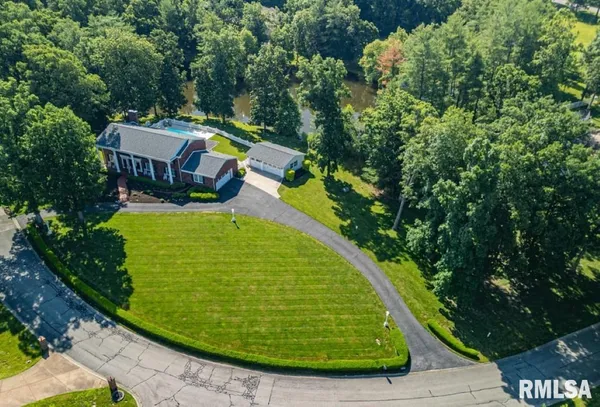 a front view of house with yard and swimming pool