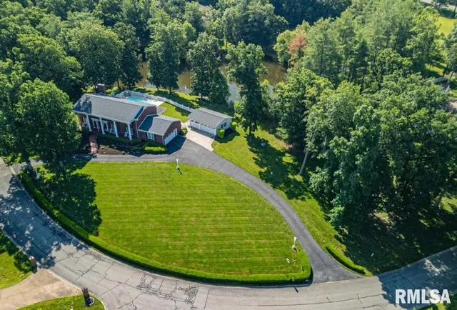 a front view of house with yard and swimming pool