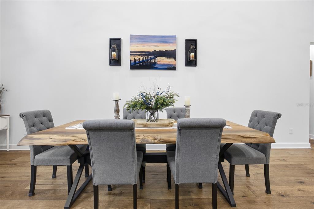 12052 Southeast 101st Court Road Belleview, FL 34420 - Photo 11 of 74 a dining room with furniture and wooden floor