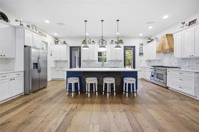 a bedroom with a bed and a flat tv screen on dresser