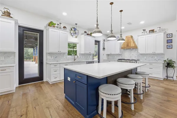 a kitchen with a refrigerator and cabinets