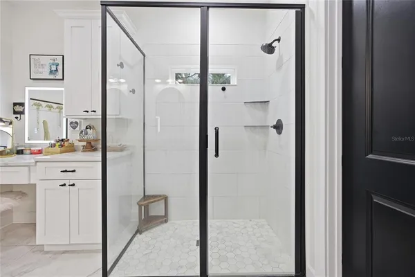 a kitchen with kitchen island a counter top space a sink stainless steel appliances and cabinets