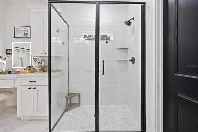 a kitchen with kitchen island a counter top space a sink stainless steel appliances and cabinets