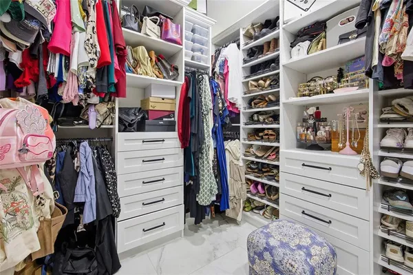 a kitchen with granite countertop white cabinets and stainless steel appliances