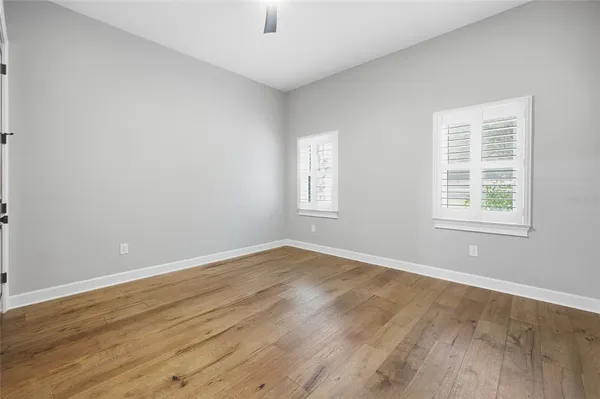 a kitchen with stainless steel appliances a table chairs in it and wooden floors